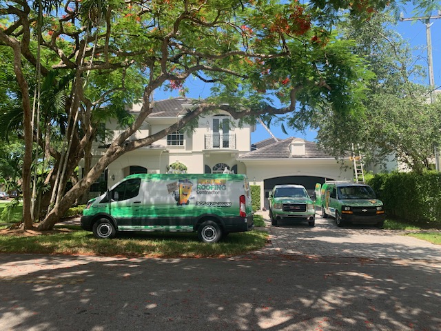 Pro-Tech Roofing company vans parked at a residential job in South Florida